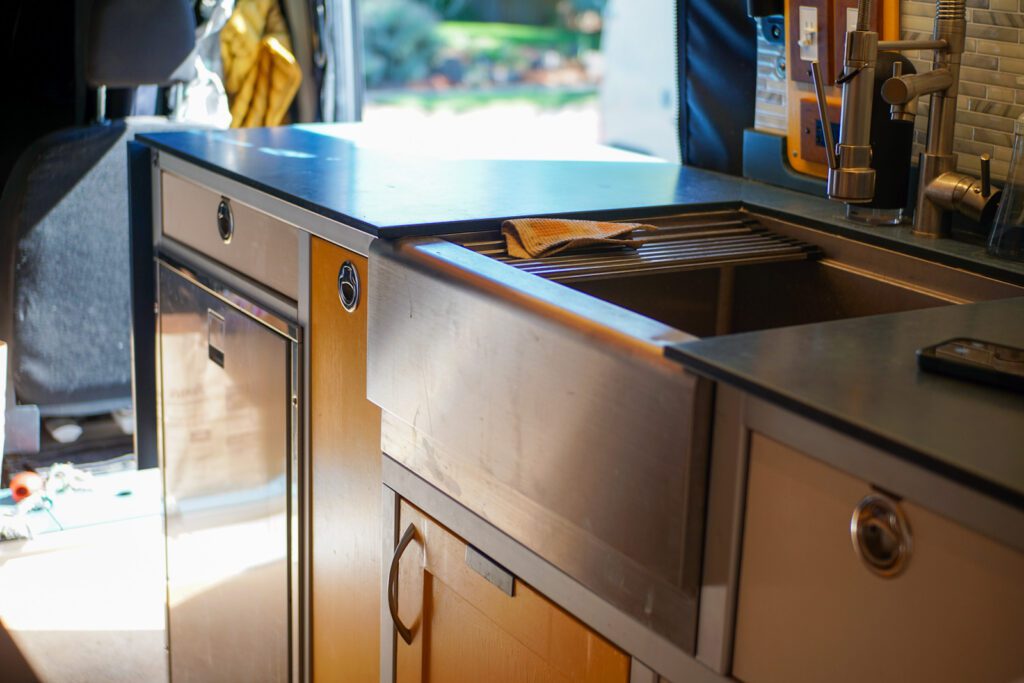 Interior view of a DIY camper van showcasing the durable 8020 aluminum framing used for a camper van galley.